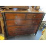 An early 19th century mahogany chest of two short and three long drawers having two rope twist