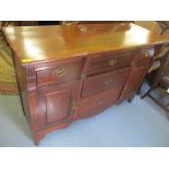 A mid 20th century sideboard having five drawers and two cupboard doors, 91cm h x 134.5cm w