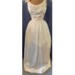 A vintage cream silk and handmade gown, possibly adapted from a wedding gown, having a bead and