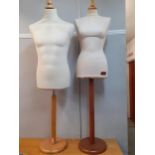 Two cloth mannequins on treen supports and stands, one in male form and the other in female form.
