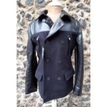 DKNY- A gents modern black woollen jacket with black leather sleeves and trim, having a thermo