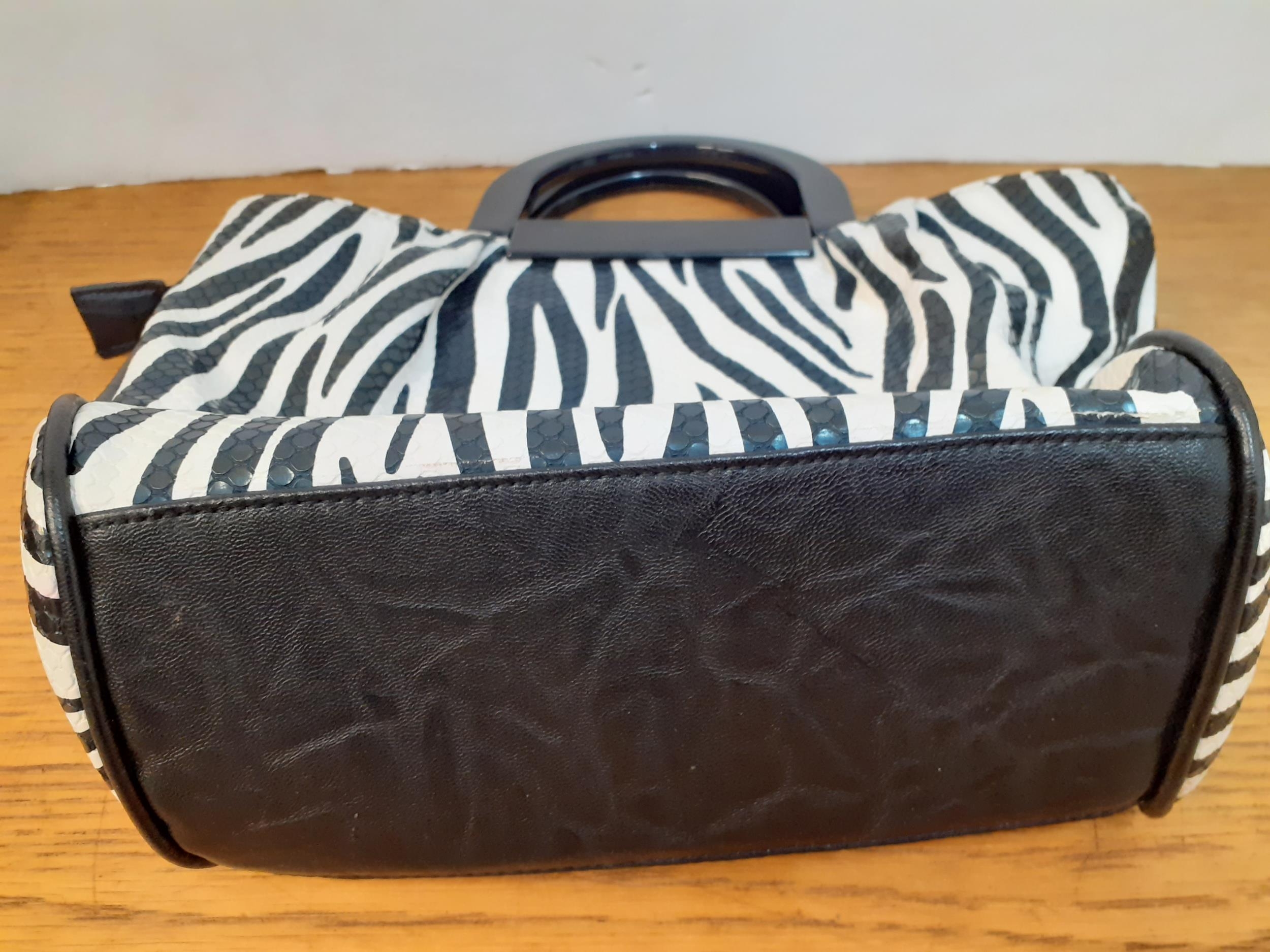 Bulaggi- Two modern bags, one in a zebra print with black resin handles and red interior having 2 - Image 4 of 4