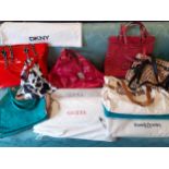 A quantity of modern handbags some new with tags and dust bags to include DKNY and Guess Location: