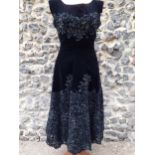 Norman Hartnell-A 1950's black velvet and applique lace three quarter, sleeveless cocktail dress,