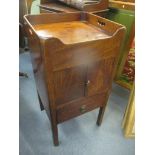 A Georgian mahogany commode with two cupboard doors above single drawer and on block shaped legs,