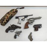 A collection of toy pistols to include a replica peacemaker revolver, cup guns and a PA JA junior