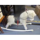 A child's rocking horse with fitted saddle and reins, on white painted runners, Location: SR