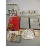 A selection of stamps in albums and loose, together with cigarette cards, some silk examples and