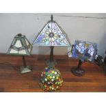 Three Tiffany style table lamps, with lead style shades and metal bases, one A/F and a similar