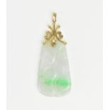 A 14ct gold mounted jade pendant carved with vegetation, the white/light green jade with bright