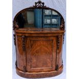 A Victorian figured walnut demi-lune credenza, with arched mirrored back in a carved frame with