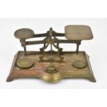 A late 19th century brass postal scales, circa 1880 with a cast brass base