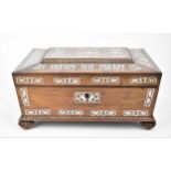 A Regency period mother of pearl inlaid rosewood sewing box, of sarcophagus form, the hinged lid