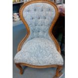 A Stuart Jones reproduction nursing chair with carved frame and blue floral upholstery Location: SL