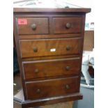 A small table top chest on a plinth base