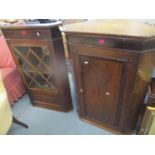 Two Georgian wall hanging corner cabinets to include a mahogany cabinet with a glazed door