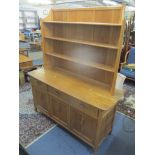 An Ercol blonde elm sideboard/dresser having a loose shelf above drawers and cupboards, 182cm h x