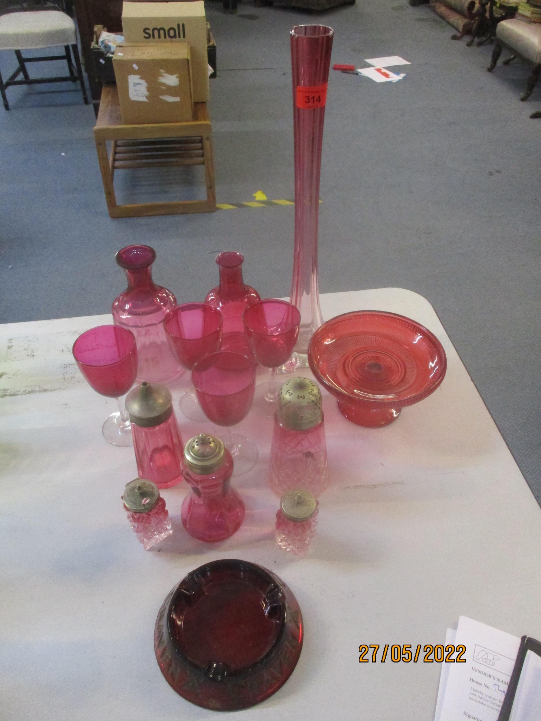A selection of Victorian cranberry and ruby glass to include a spill vase, carafes, sugar casters