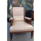 A Victorian mahogany framed gentleman's armchair, upholstered in leather, on turned forelegs and a
