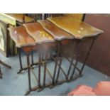 A nest of four early/mid 20th century mahogany tables on turned legs, the largest 70h x 57w