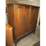 A Chinese hardwood four door marriage cabinet, brass fittings, interior fitted with open shelves and
