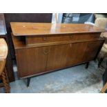 A mid 20th century G-Plan, walnut finished sideboard with drawers and a pair of folding doors,