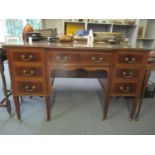 An early 20th century mahogany sideboard with central long drawer flanked by six short drawers and