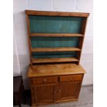 An early 20th century pine dresser with a plate rack over two drawers and two doors, 203cm h,
