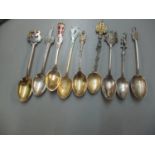 A group of six silver souvenir spoons to include enamel examples, together with a stamped 800 Milano