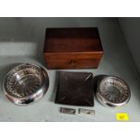 Two silver plated cigar cutters and a mahogany humidor, along with an Alessi ash tray and others
