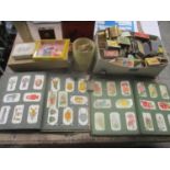 A mixed lot to include a collection of vintage match boxes, two albums of cigarette cards, school