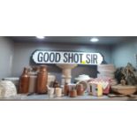 A modern Good Shot Sir sign in the form of a street sign and vintage kitchen items, stoneware