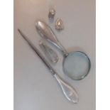 A quantity of silver items to include a fob, a silver handled magnifier, a silver handled paper