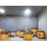 A collection of Doulton stoneware tobacco jars to include one decorated with a sailing vessel and