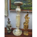 An alabaster pedestal with a turned column, a gilt plaster figural lamp, and a Chinese cloisonné