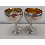 A pair of silver pedestal wine goblets with initials PC to one and GC to the other, 459g Location: