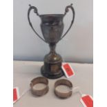 A silver plated 1950's trophy together with two silver napkin rings, 28.3g Location:Porters