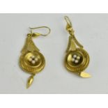 A pair of gold coloured earrings, each set with four seed pearls, set in a concave disc, engraved