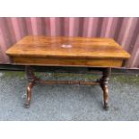 A William IV rosewood centre table with a long frieze drawer, over twin turned carved columns with