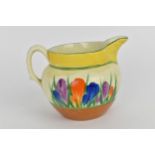 A Clarice Cliff 'Crocus' pattern milk jug from the 'Bizarre' collection, hand painted with purple,