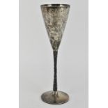 A 1970s silver champagne flute by Stuart Devlin, the conical bowl above a textured stem with