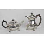 A George V silver teapot and hot water pot by Docker & Burn Ltd, Birmingham 1924, with faceted