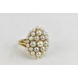 An 18ct yellow gold ring set with numerous graduating pearls, (one deficient), stamped PG LD, size