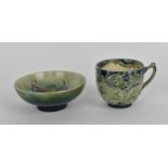 A William Moorcroft Florian ware cup, with tube lined foliate design in green and blue tones, with