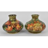 A pair of Moorcroft pottery vases designed by Philip Gibson, in the 'Flame of the Forest' pattern,