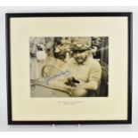 A signed reprinted photograph of Jose Froilan Gonzalez in a BRM racing car 1952, 18.5cm x 24.5cm