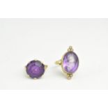 A gold coloured ring and a gold plated ring set with seed pearls, each set with a purple stone