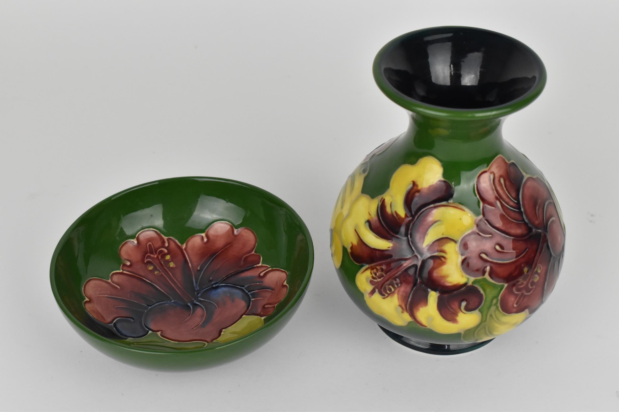 A Moorcroft pottery 'Hibiscus' pattern vase, designed with globular body and everted rim decorated