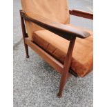 A Guy Rogers Manhattan teak framed open reclining armchair with brown dralon upholstery, on