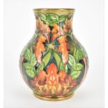 A late 20th century Moorcroft pottery vase designed by Philip Gibson, in the 'Flame of the Forest'